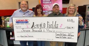 Presenting Angie Fields with check for Breast Cancer Awareness Month